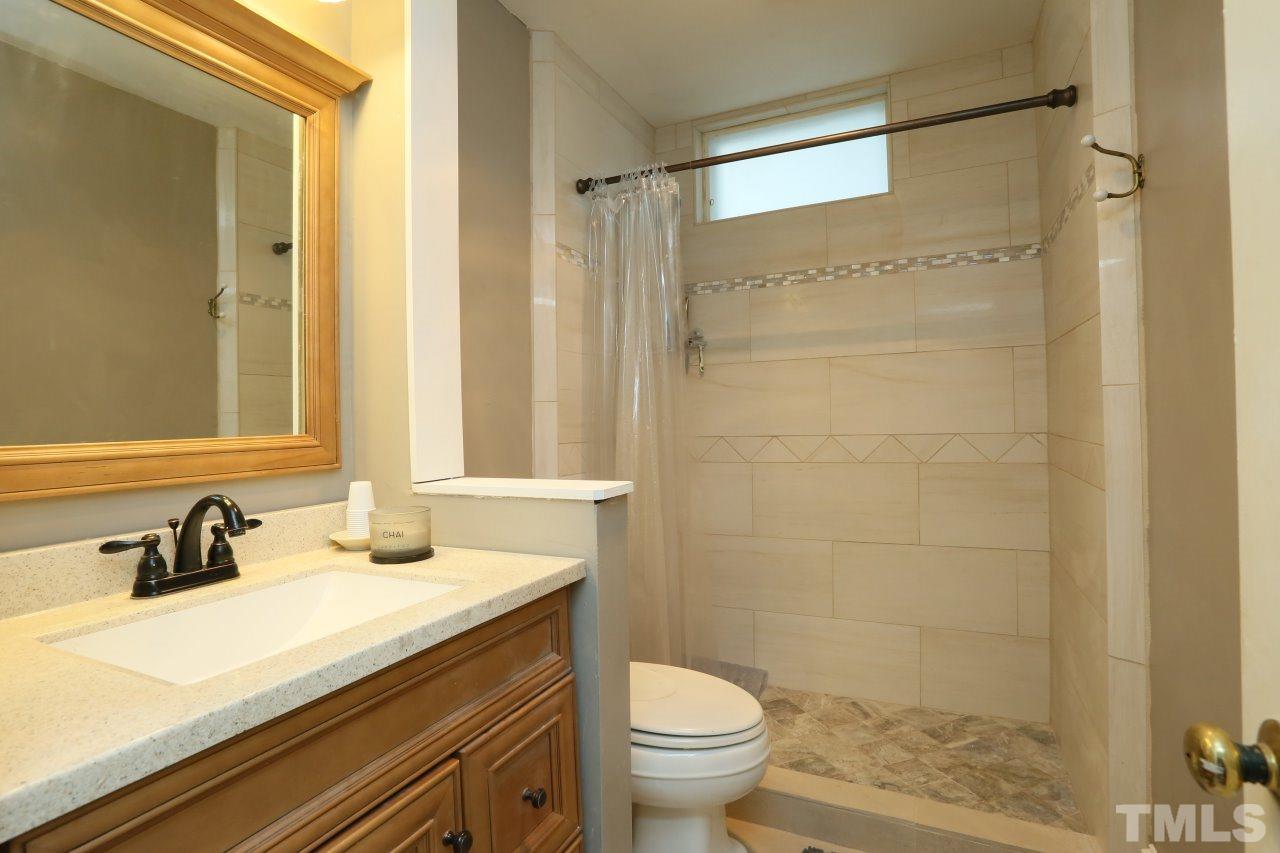 526 North Person Street Raleigh, NC 27604 - Photo 18 of 25 a bathroom with a sink and a mirror