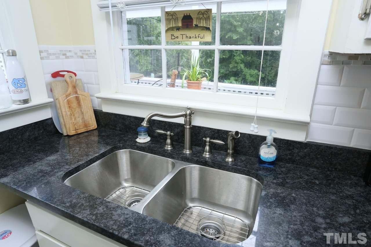 526 North Person Street Raleigh, NC 27604 - Photo 10 of 25 a kitchen with a sink a counter space and a window