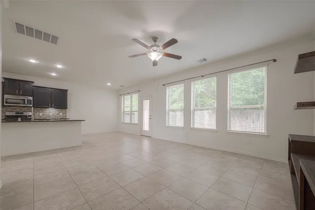 a view of an empty room with a kitchen