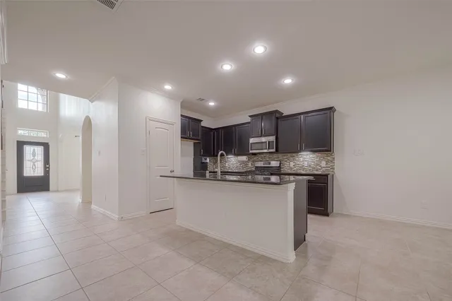 a open kitchen with stainless steel appliances granite countertop a sink and cabinets