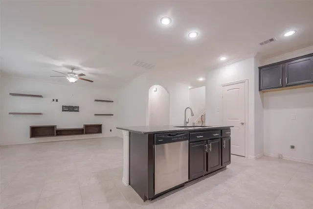 a kitchen with kitchen island a sink stainless steel appliances and cabinets