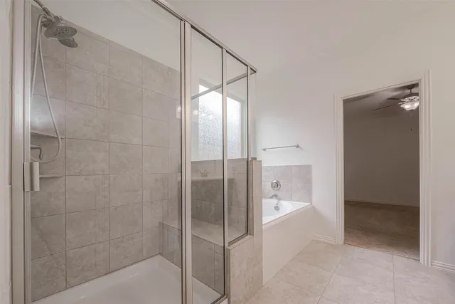 a bathroom with a glass shower door and a bathroom