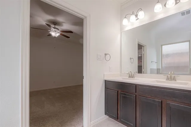 a bathroom with a double vanity sink and mirror
