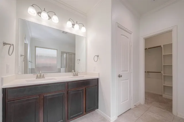 a bathroom with a double vanity sink and a mirror