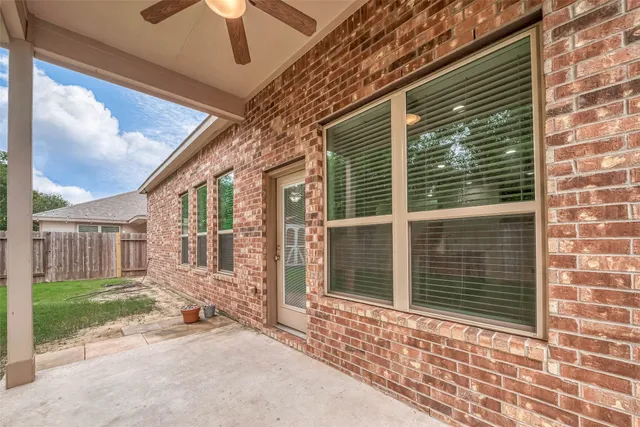 a view of a brick house with a large window