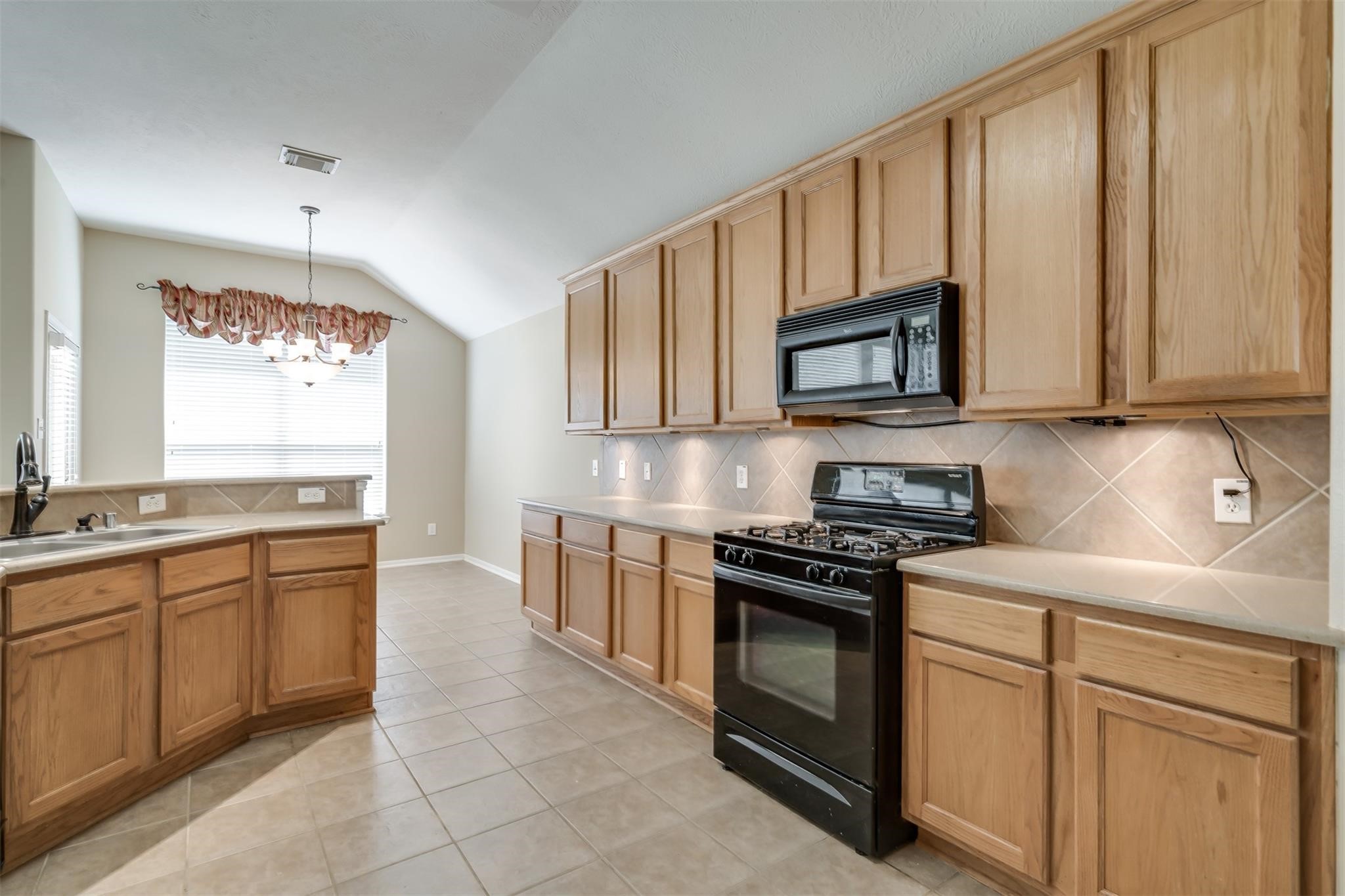 3419 La Fleur Lane Spring, TX 77388 - Photo 13 of 26 a kitchen with stainless steel appliances granite countertop a stove sink and cabinets