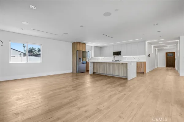 a view of kitchen with furniture and wooden floor
