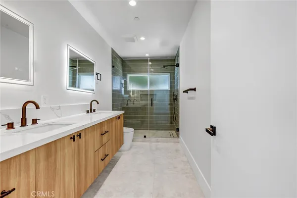 a bathroom with a double vanity sink and mirror