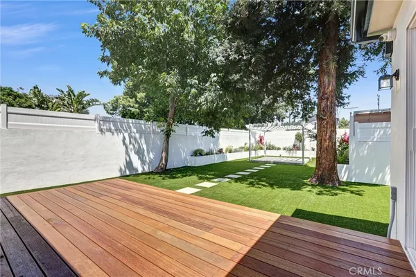 a view of a backyard with wooden fence