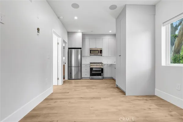 a view of a kitchen with a sink and a fireplace