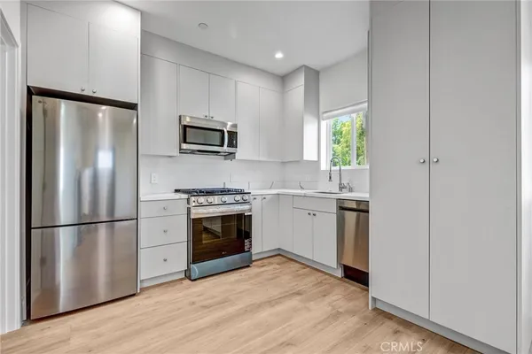 a kitchen with a refrigerator stove and microwave