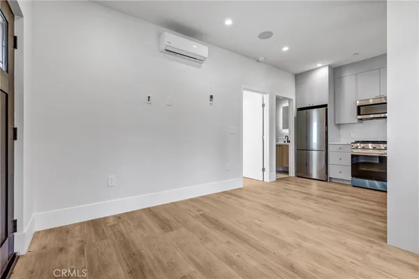 a view of a kitchen with refrigerator and an oven