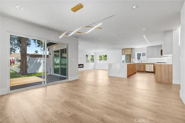 a view of a kitchen with a sink and a large window