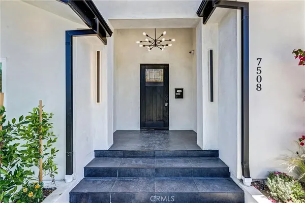 a view of a hallway with wooden door and staircase