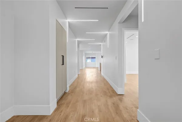 a view of a hallway with wooden floor