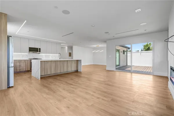 a view of a kitchen with a sink cabinets and wooden floor
