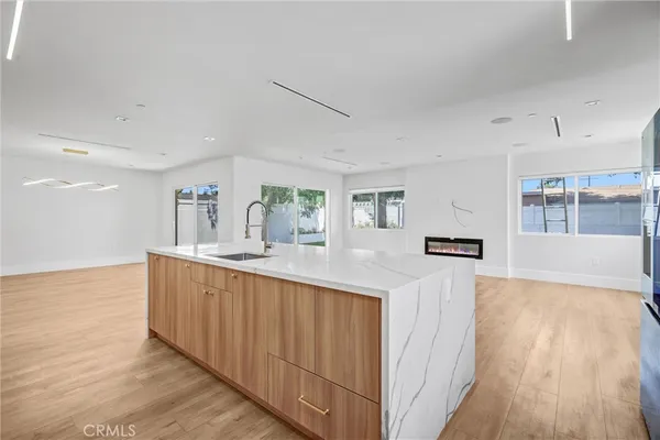 a kitchen with stainless steel appliances granite countertop a sink and a wooden floors