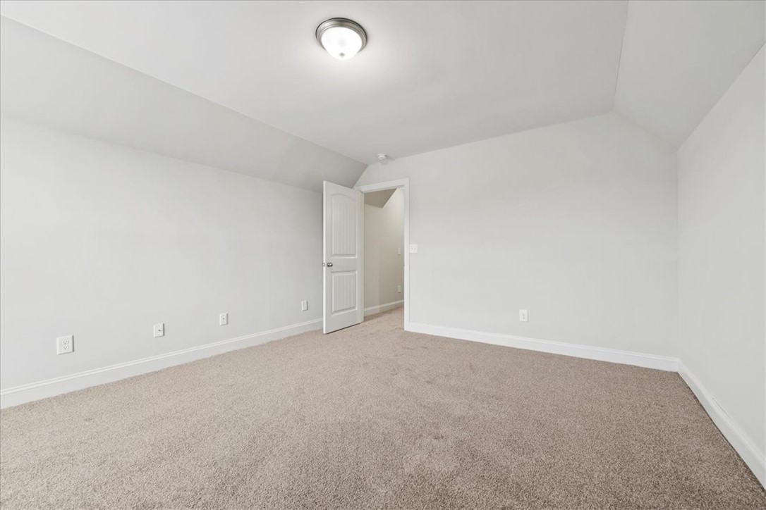 102 Ripplestone Way Anderson, SC 29621 - Photo 31 of 39 A spacious room offers ample potential, featuring soft carpeting and a bright overhead light.
