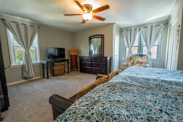a bedroom with furniture and a flat screen tv