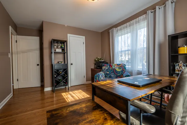a living room with furniture and wooden floor