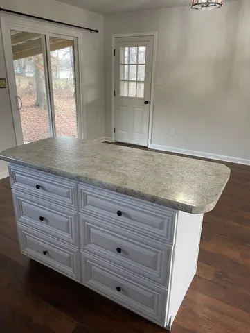 a view of room with window and wooden floor