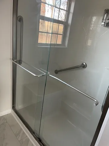 a bathroom with a glass shower door