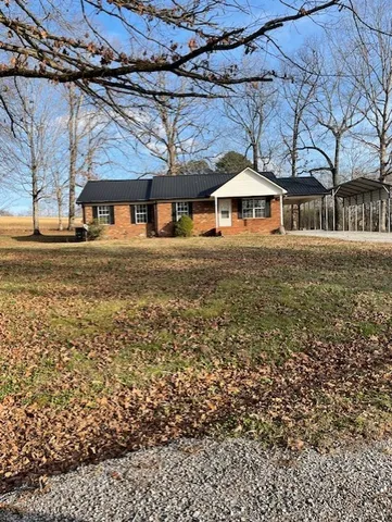 a yellow house with a yard