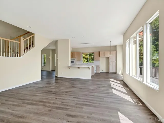 a view of a kitchen with furniture and wooden floor