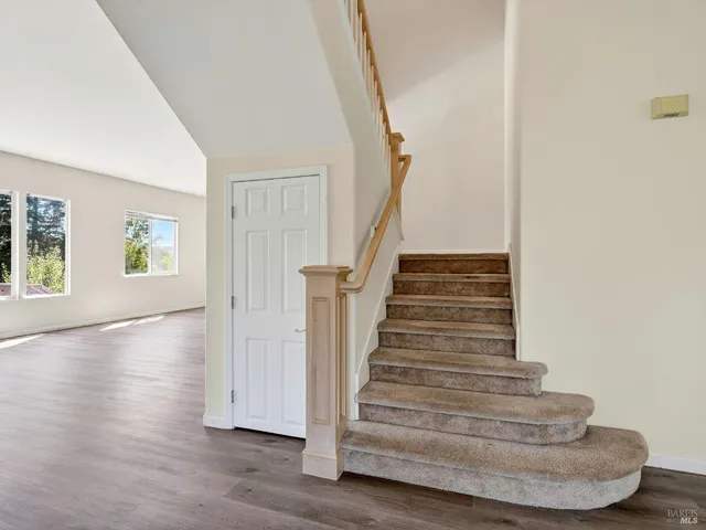 a room with furniture a large window and a flat screen tv