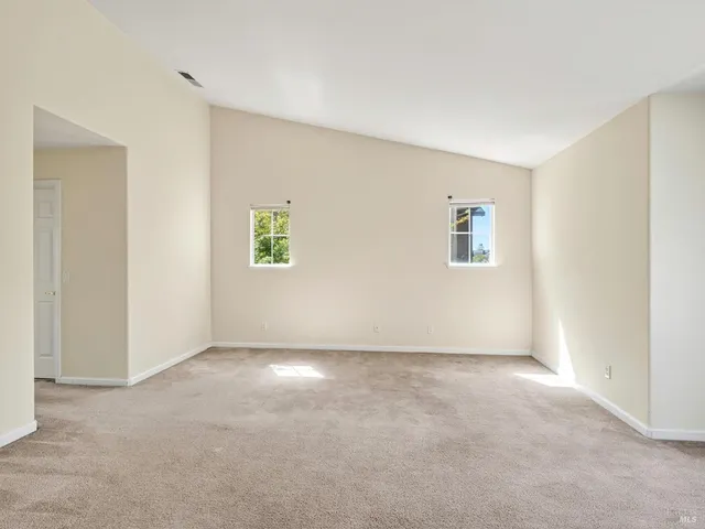 a balcony with wooden floor and yard in the back