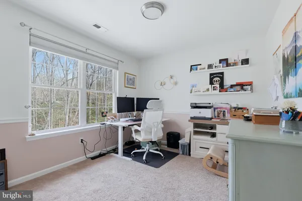 a reading room with furniture a flat screen tv and a window