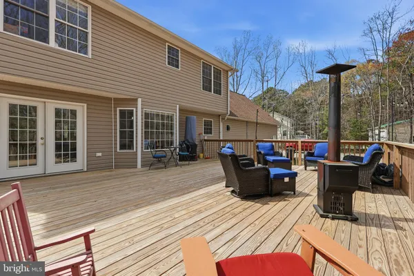 a view of a roof deck with furniture