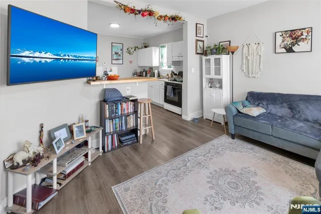 a living room with furniture and a chandelier