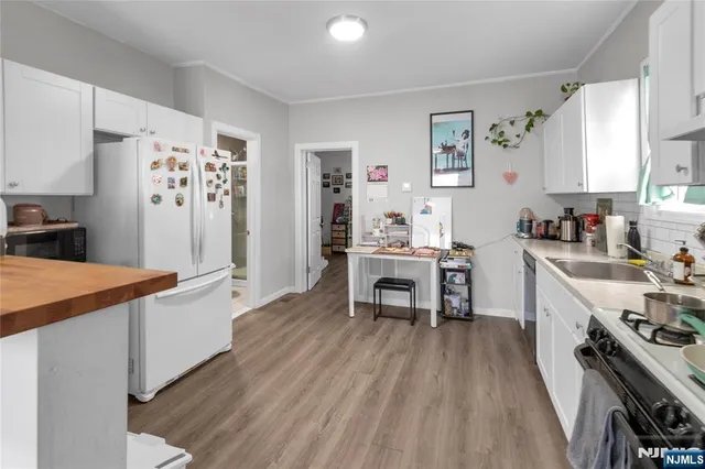 a kitchen with stainless steel appliances a stove a sink dishwasher and a refrigerator