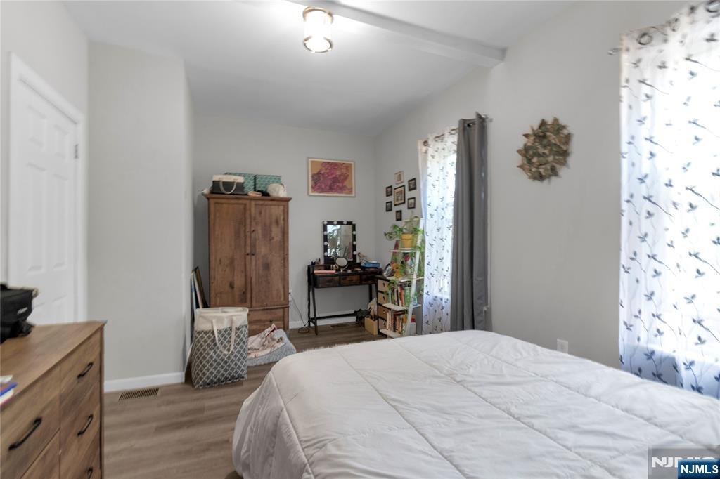 26 Grand Street, Unit 1 Garfield, NJ 07026 - Photo 6 of 7 a bedroom with a bed and a dresser in it