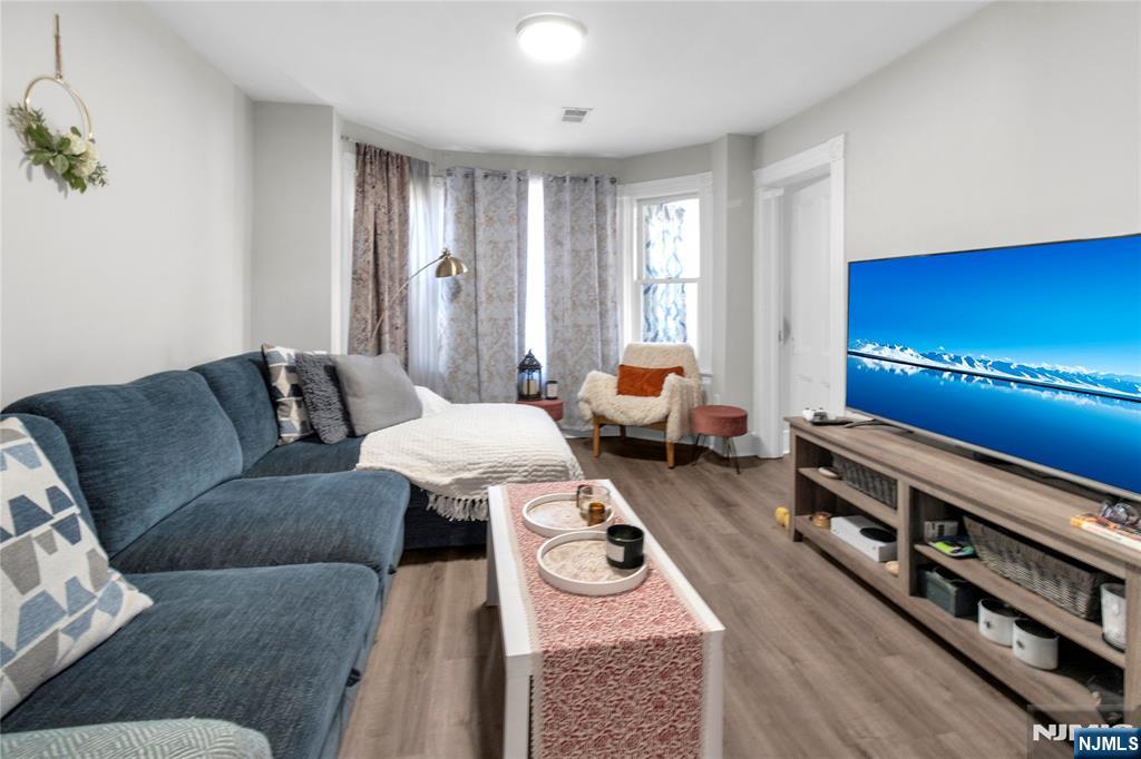 26 Grand Street, Unit 1 Garfield, NJ 07026 - Photo 7 of 7 a living room with furniture and a flat screen tv