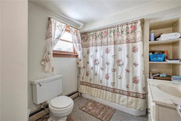 a bathroom with a toilet a sink and a window