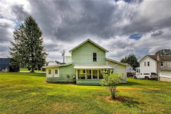 a front view of house with yard and green space