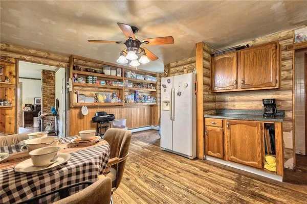 a kitchen with stainless steel appliances kitchen island granite countertop a refrigerator and microwave