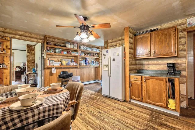 a kitchen with stainless steel appliances kitchen island granite countertop a refrigerator and microwave