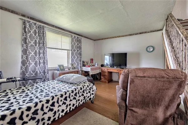 a bedroom with a bed and flat screen tv