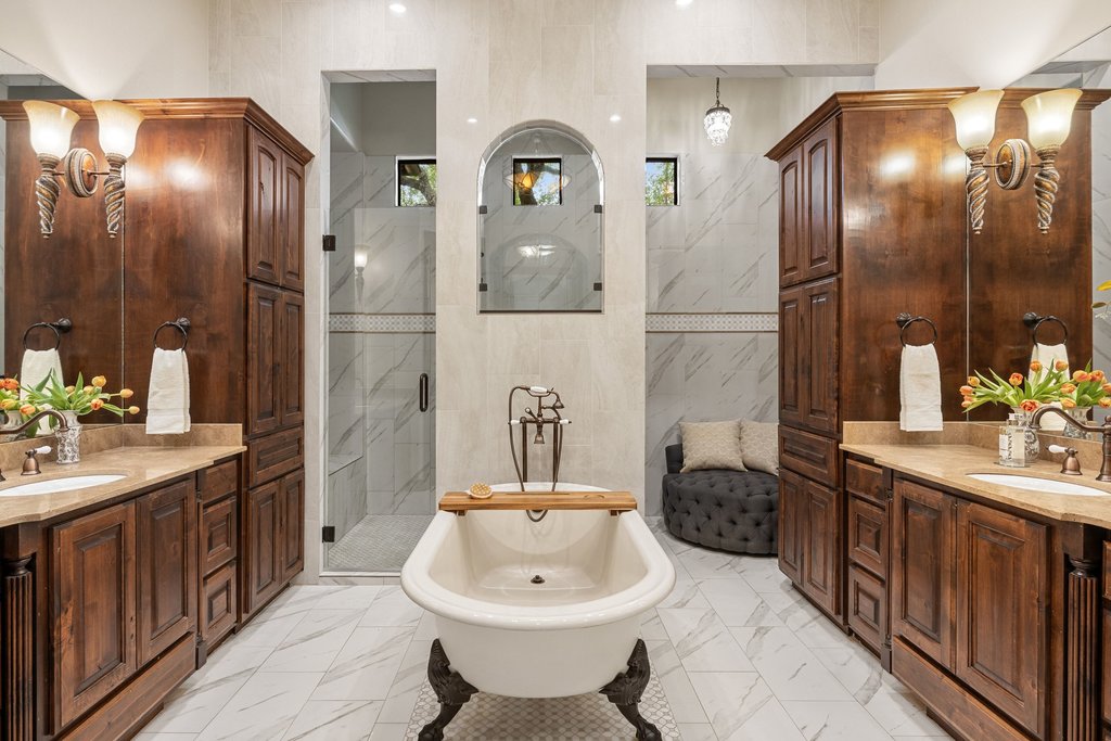 1540 County Road 262 Georgetown, TX 78633 - Photo 15 of 40 The ensuite bath is nothing short of a private retreat, with a freestanding soaking tub, a separate walk-in shower, a dedicated dressing nook, two distinct vanities, and two walk-in closets.