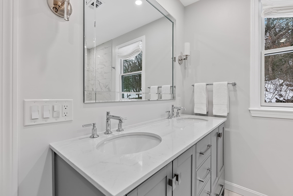 34 Pleasant Street, Unit 5 Wellesley, MA 02482 - Photo 13 of 31 a bathroom with a sink and a mirror