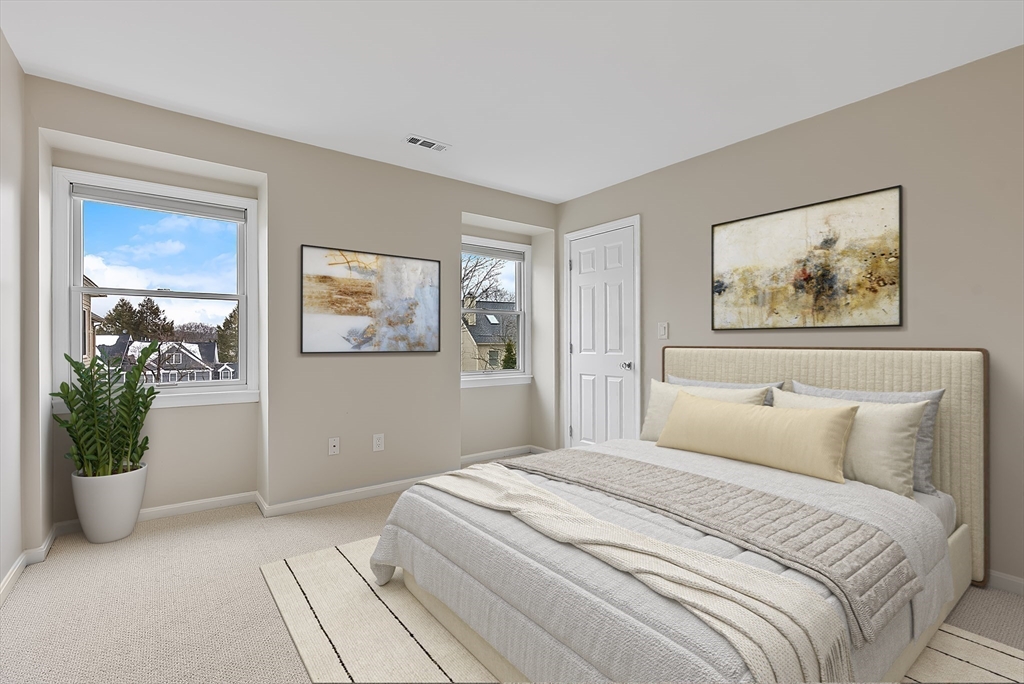 34 Pleasant Street, Unit 5 Wellesley, MA 02482 - Photo 14 of 31 a bedroom with a large bed and a potted plant