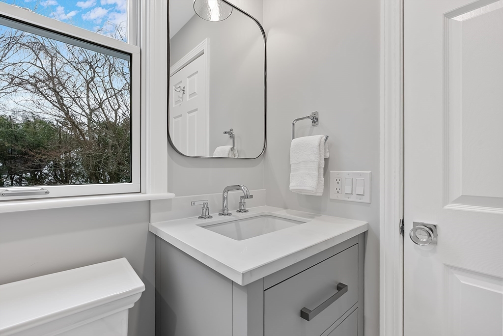34 Pleasant Street, Unit 5 Wellesley, MA 02482 - Photo 16 of 31 a bathroom with a sink and a mirror