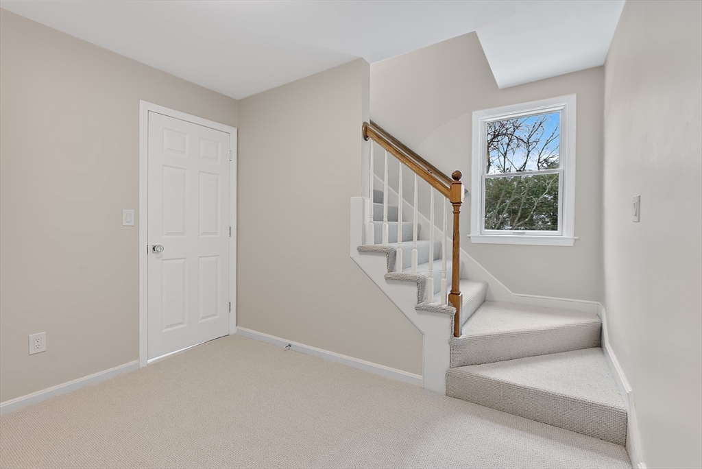 34 Pleasant Street, Unit 5 Wellesley, MA 02482 - Photo 18 of 31 a view of staircase with white walls and a window