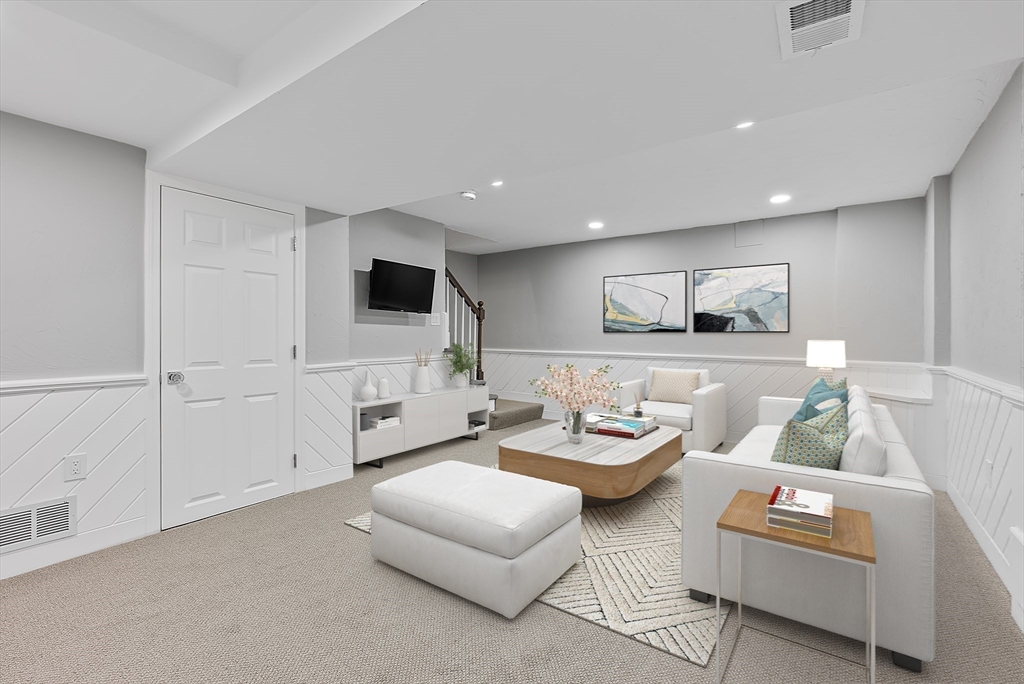 34 Pleasant Street, Unit 5 Wellesley, MA 02482 - Photo 21 of 31 a living room with furniture and a flat screen tv