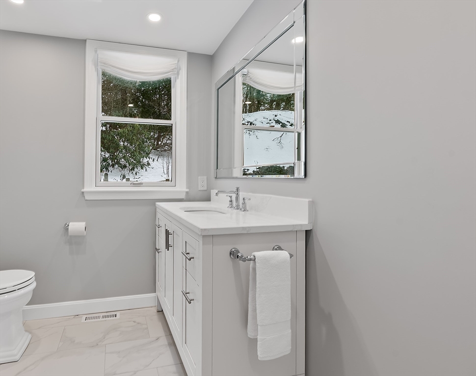 34 Pleasant Street, Unit 5 Wellesley, MA 02482 - Photo 9 of 31 a bathroom with a sink a toilet and shower