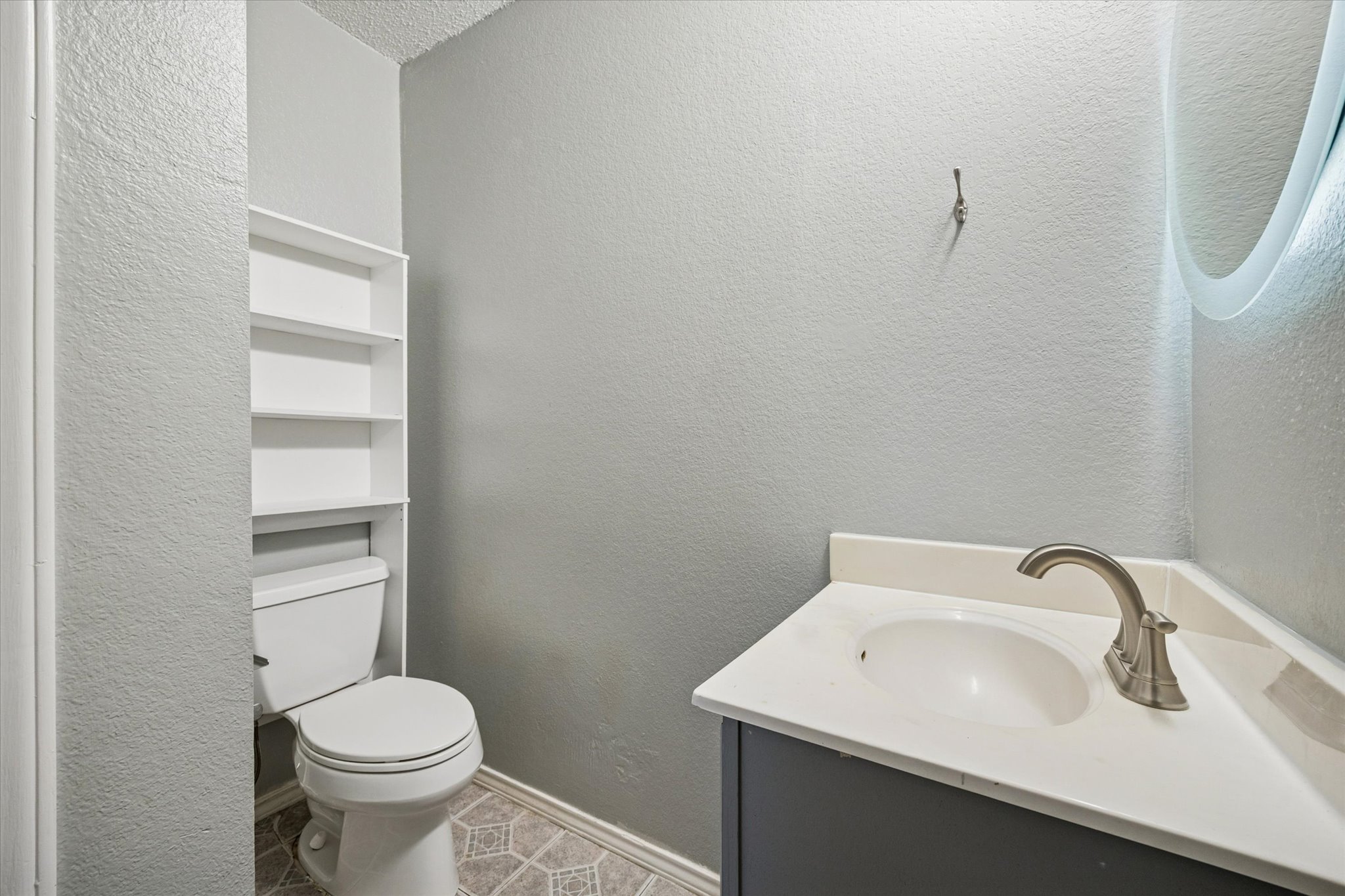 23393 Nameless Road, Unit 152 Leander, TX 78641 - Photo 6 of 10 Bathroom featuring a textured wall and vanity