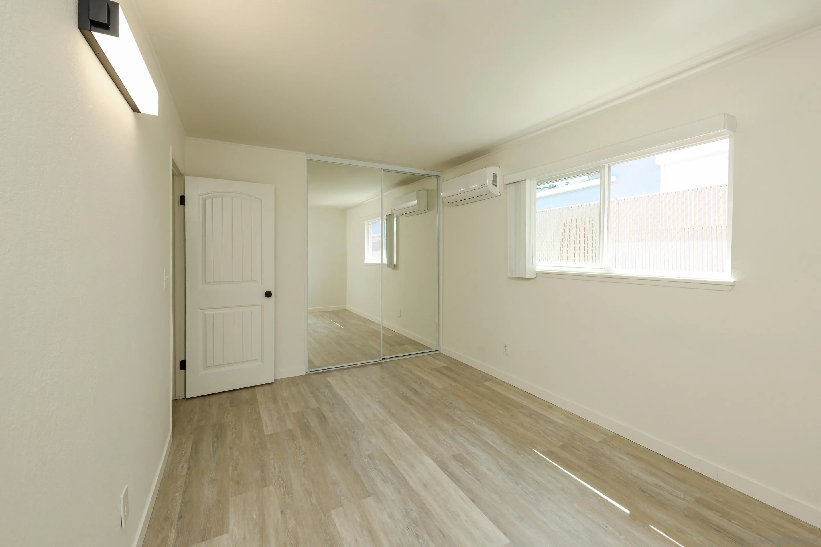 11102 Shadow Hill Way Santee, CA 92071 - Photo 13 of 30 an empty room with wooden floor and windows